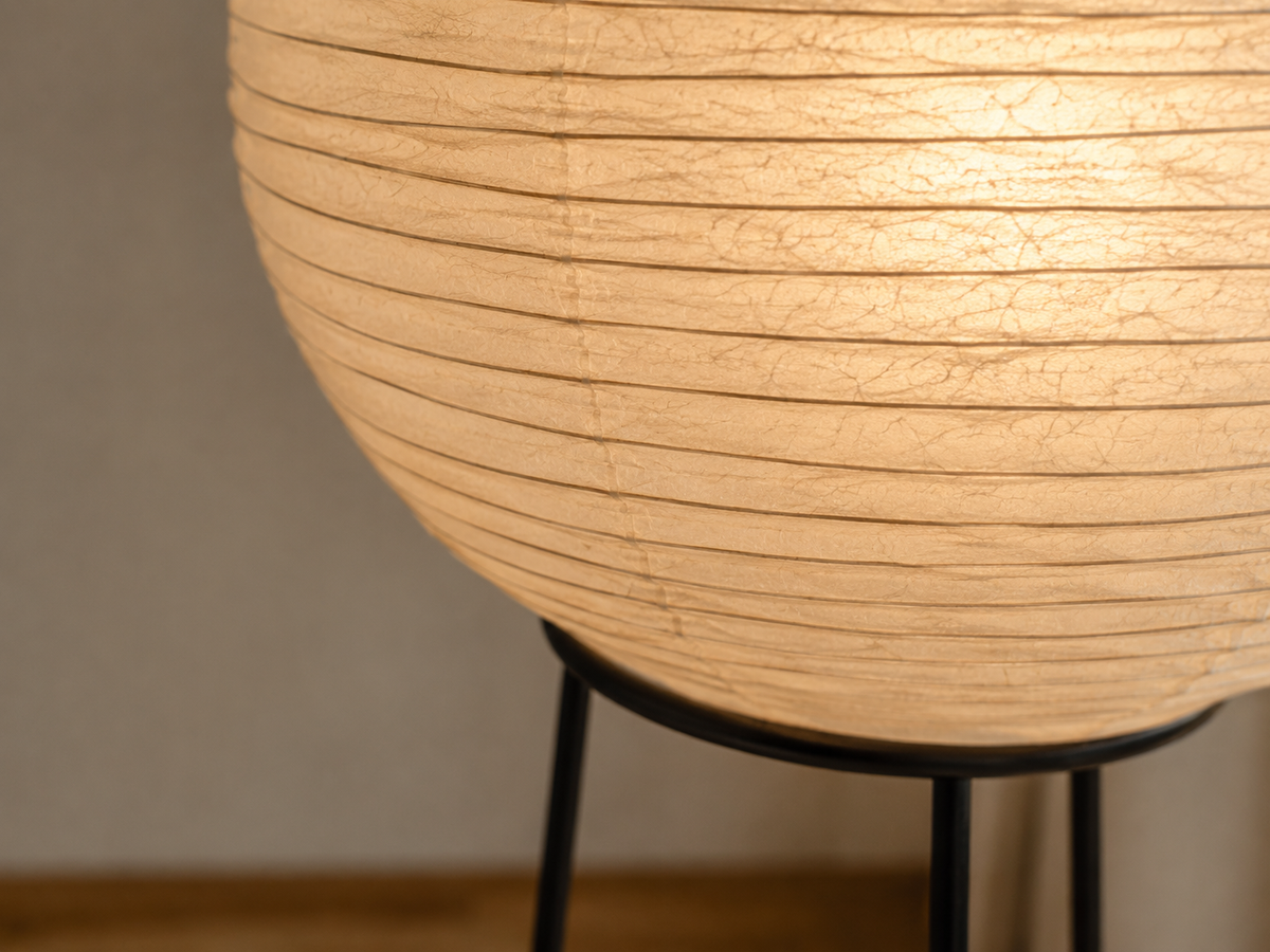 Washi globe floor lamp in a warm Japandi living room beside a sofa