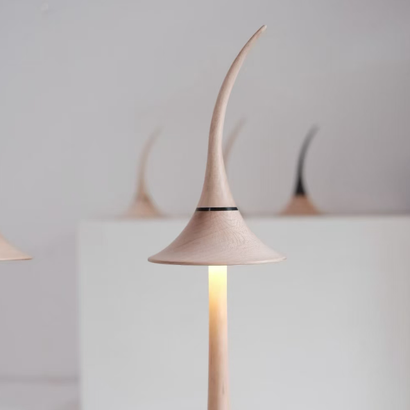 Modern floor lamp with a unique design on a plain background