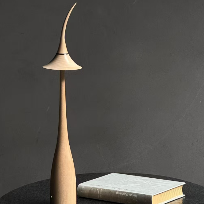 Modern lamp with a book on a dark surface against a dark background