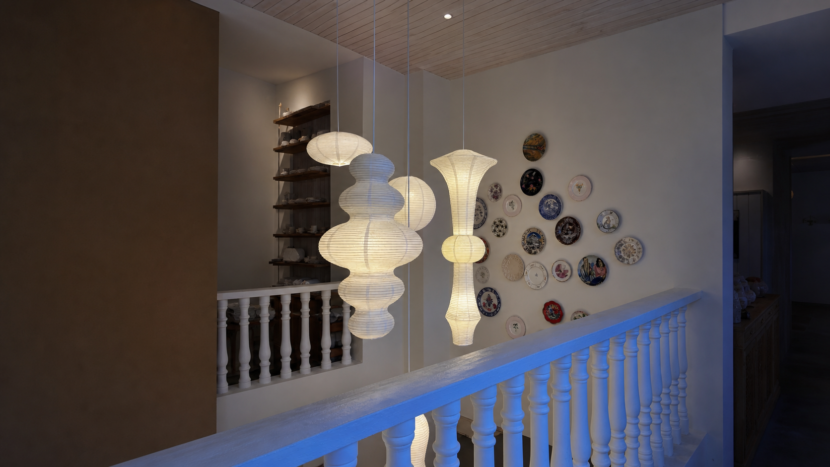 Sculptural paper pendant lights in a warm interior gallery