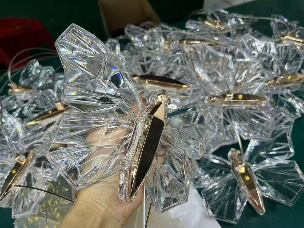 Clear butterfly-shaped lighting components with gold trim