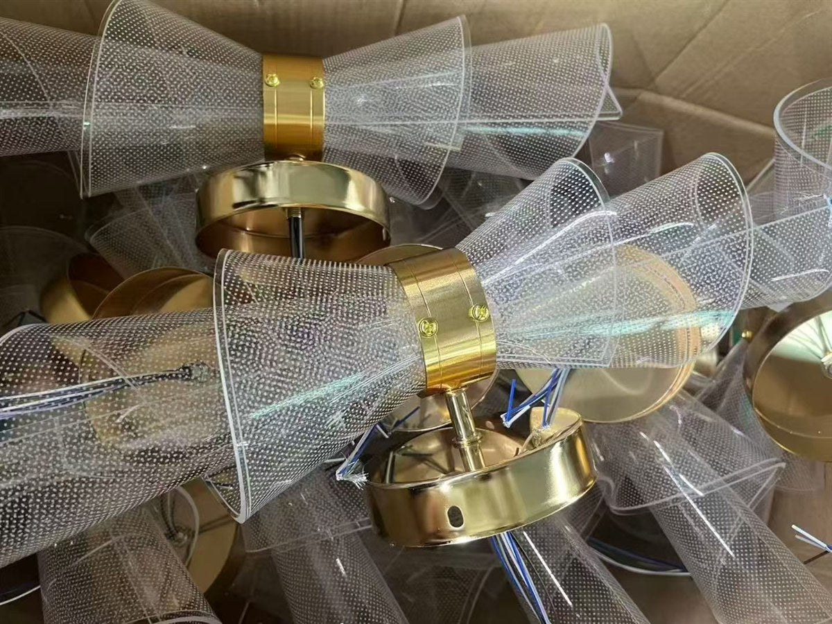 Clear textured shades and gold fittings ready for assembly